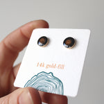 Load image into Gallery viewer, black and brown wood earrings sit against a soft white background. 
