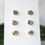 Load image into Gallery viewer, floral wood studs on paper stand, blue resin and wood with greenery in background

