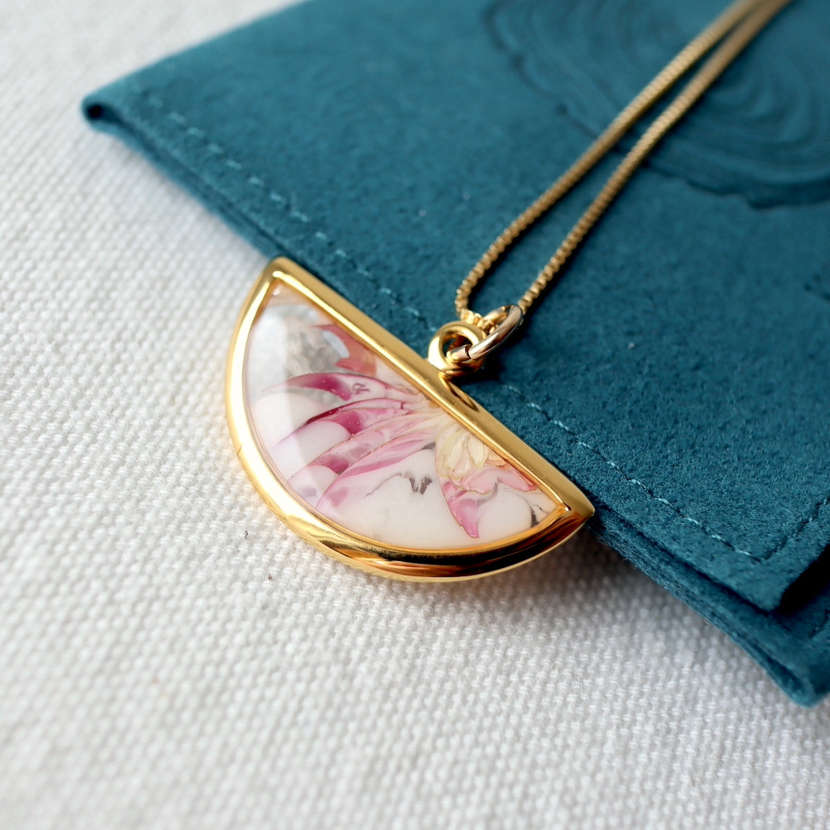 Florals. Encased Gold Half-moon Necklace with Dahlia Flowers